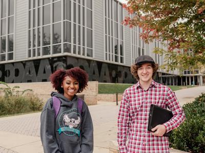 Students standing in front of library